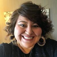 Headshot of smiling Latina with short brown hair